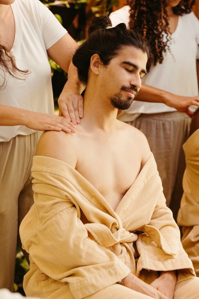 A man enjoys a relaxing shoulder massage in a peaceful spa setting, promoting relaxation and wellness.